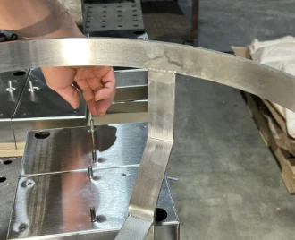 A welder adding a small piece of metal to be welded
